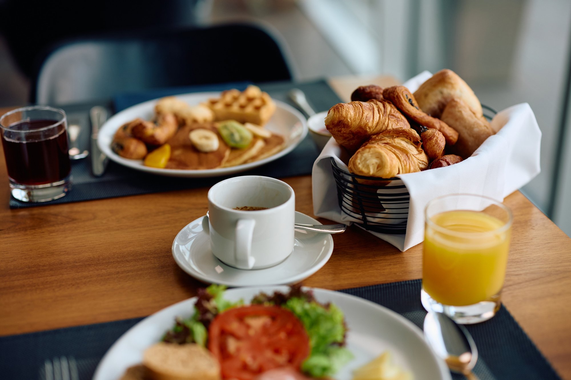 Close-up-of-dining-table-during-breakfast-in-a-hotel.-2077441223_2125x1416