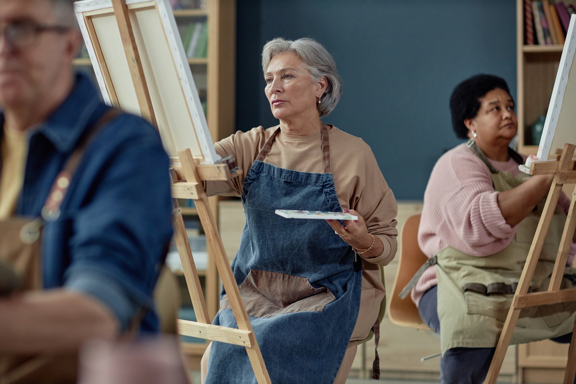 Elegant-Mature-Woman-Painting-in-Art-Studio-2164427169_2125x1416