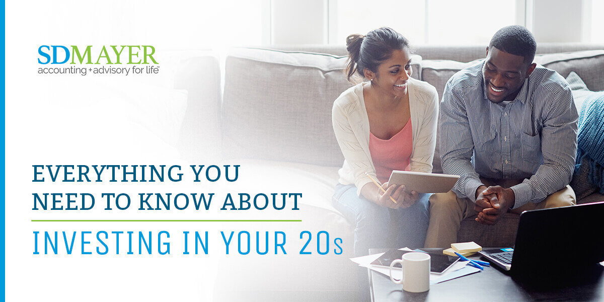 Couple looking at their finances. Text, "everything you need to know about investing in your 20s"
