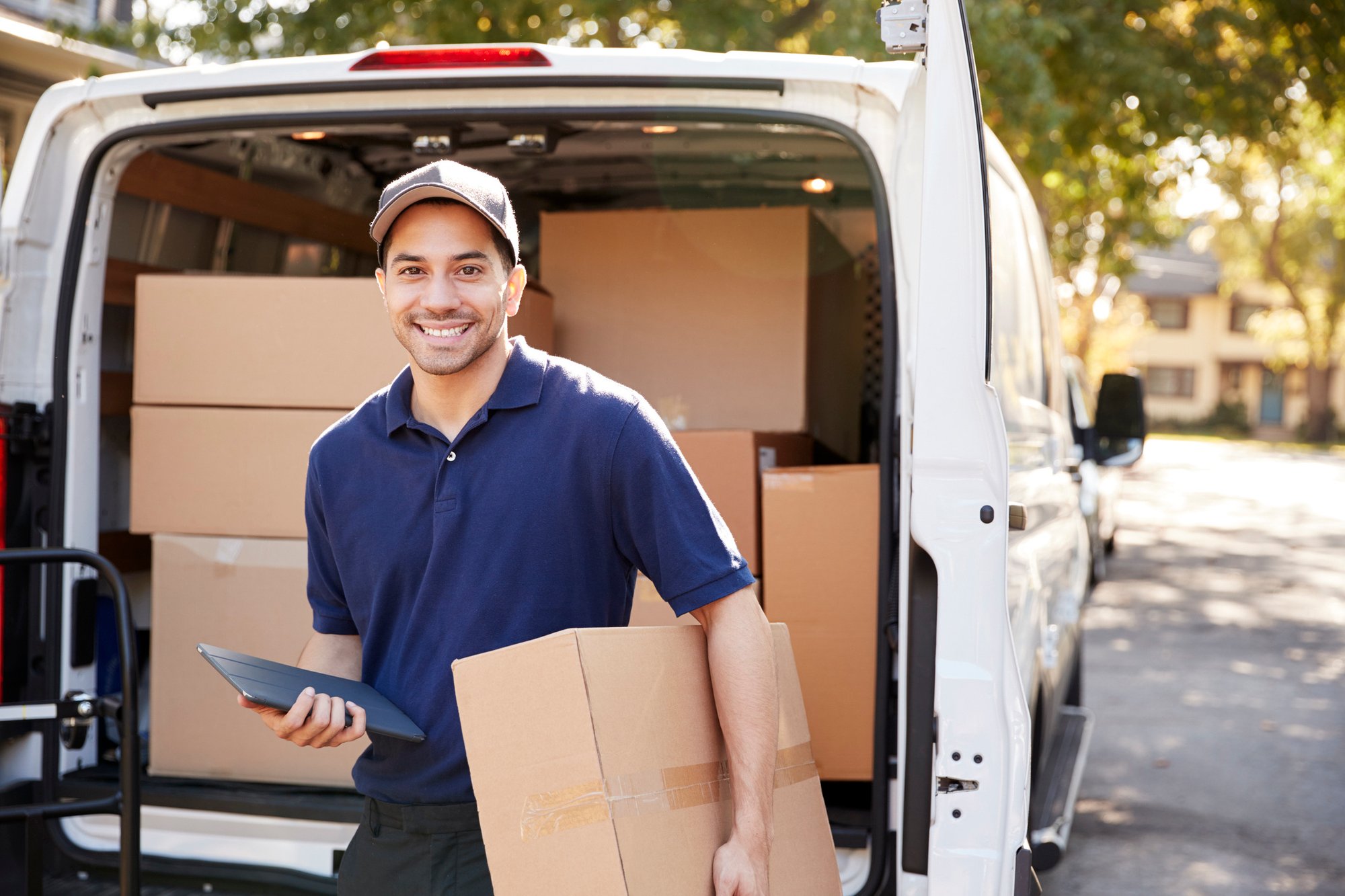 Portrait-Of-Courier-With-Digital-Tablet-Delivering-Package-905865682_2124x1416-1