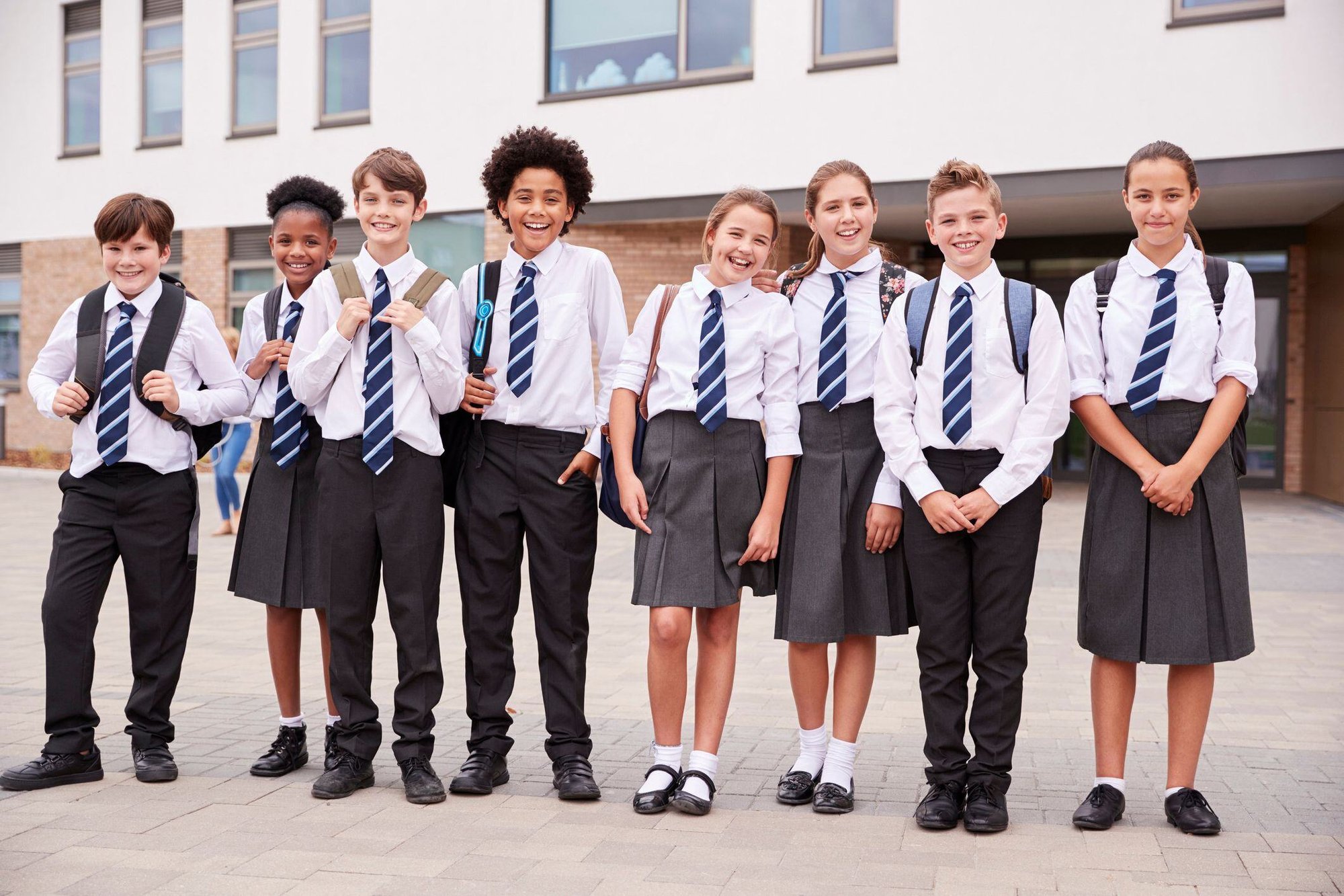 Portrait-Of-High-School-Student-Group-Wearing-Uniform-Standing-Outside-School-Buildings-1047620596_2125x1416