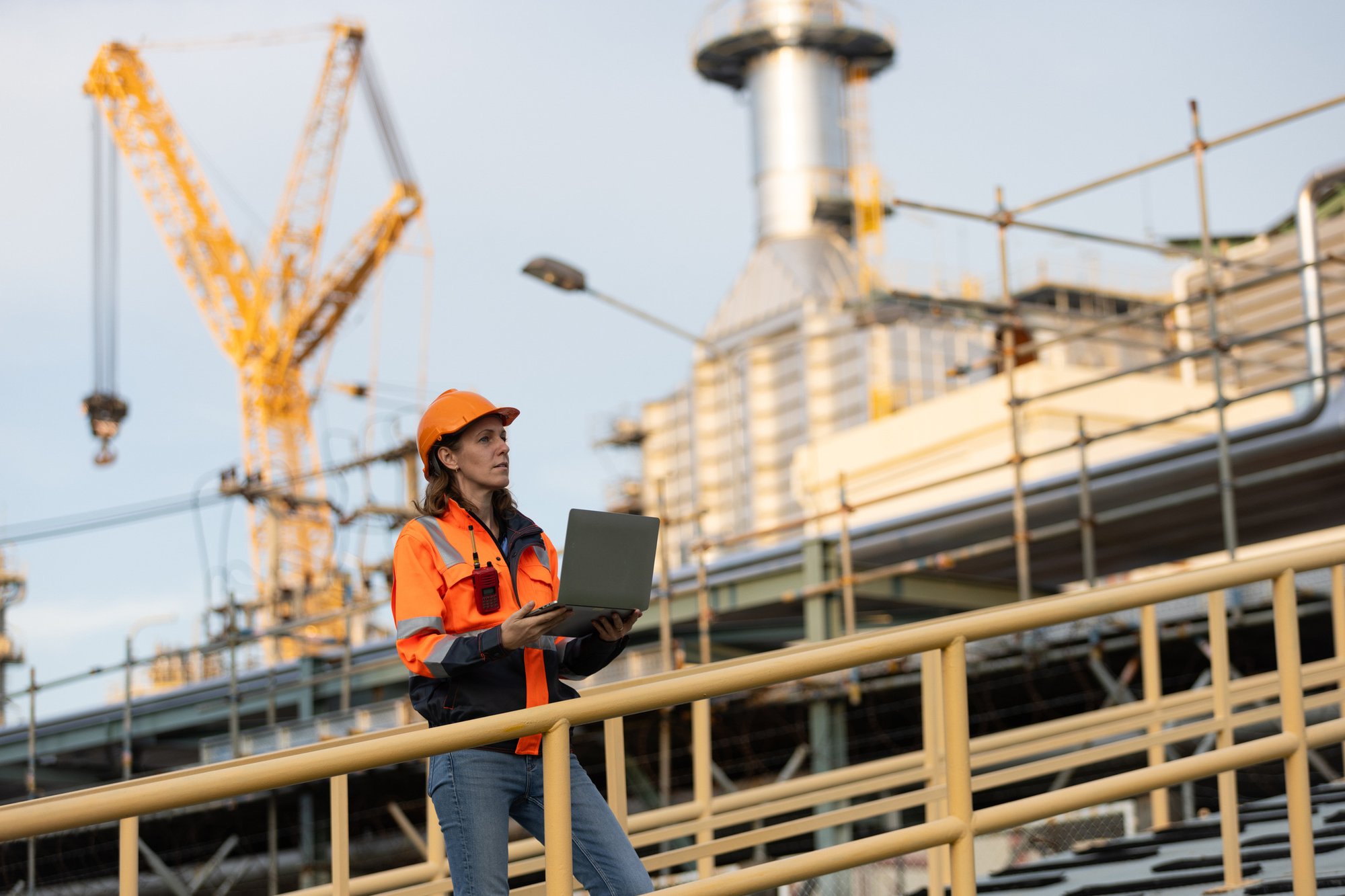 The-confident-Female-oil-engineer-working-at-Oil-refinery-outdoors.-Engineer-holding-oil-and-gas-production-checklist.-Blue-collar-Worker-of-Oil-and-Gas-industry-concepts.-2175487782_2123x1416