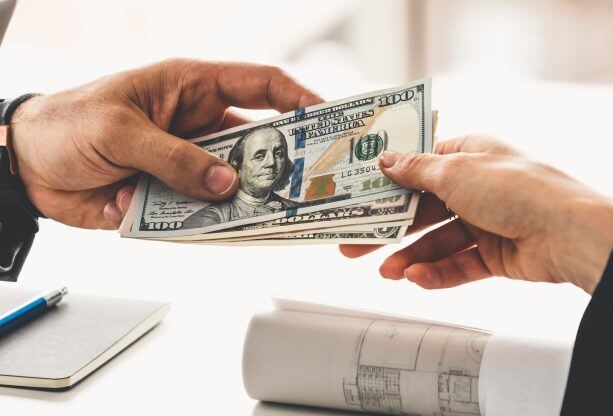 Transfer-of-money-from-hand-to-hand.-1126636063_2123x1416-613x416