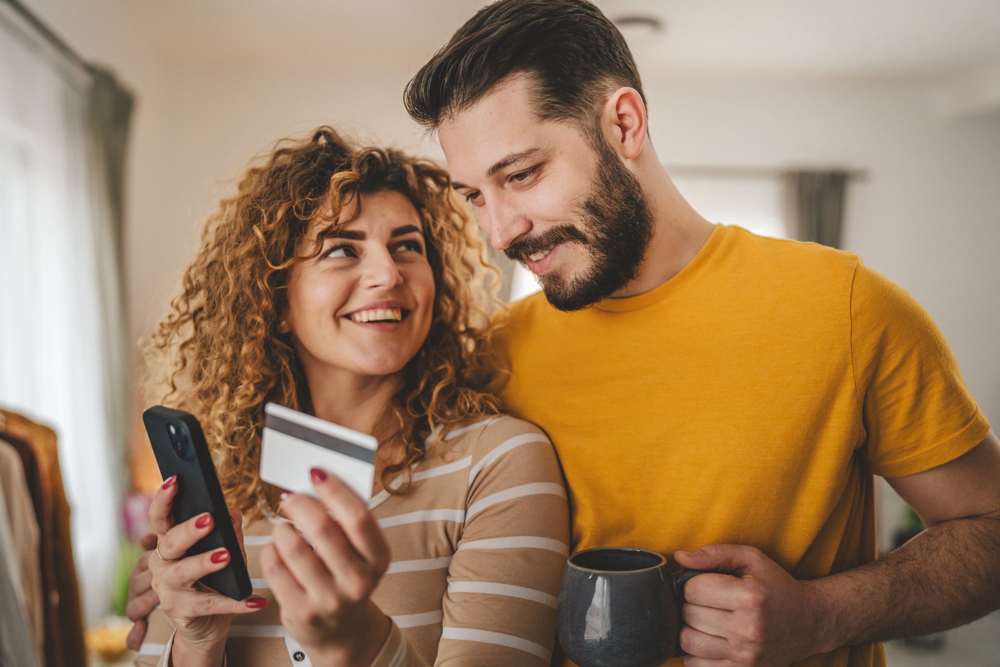adult-happy-couple-man-and-woman-shopping-online-hold-credit-card-2020314708_2125x1417