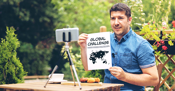 man holding global challenge paper