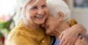 two women with white hair hugging