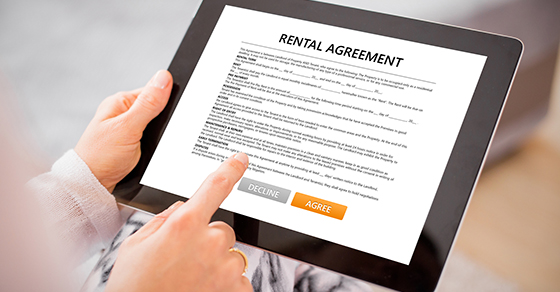 pointing to rental agreement on tablet