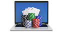 poker chips and cards on laptop