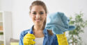 woman cleaning glass wearing yellow gloves