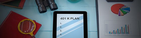 tablet with 401k plan on desk with magnifying glass and data sheet