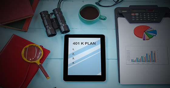 tablet with 401k plan on desk with magnifying glass and data sheet