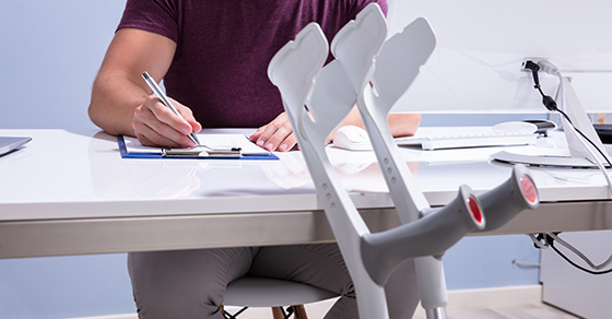 disabled person writing on desk