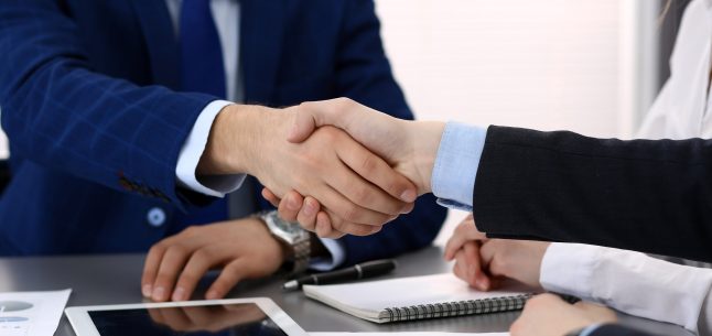 shaking hands in business setting