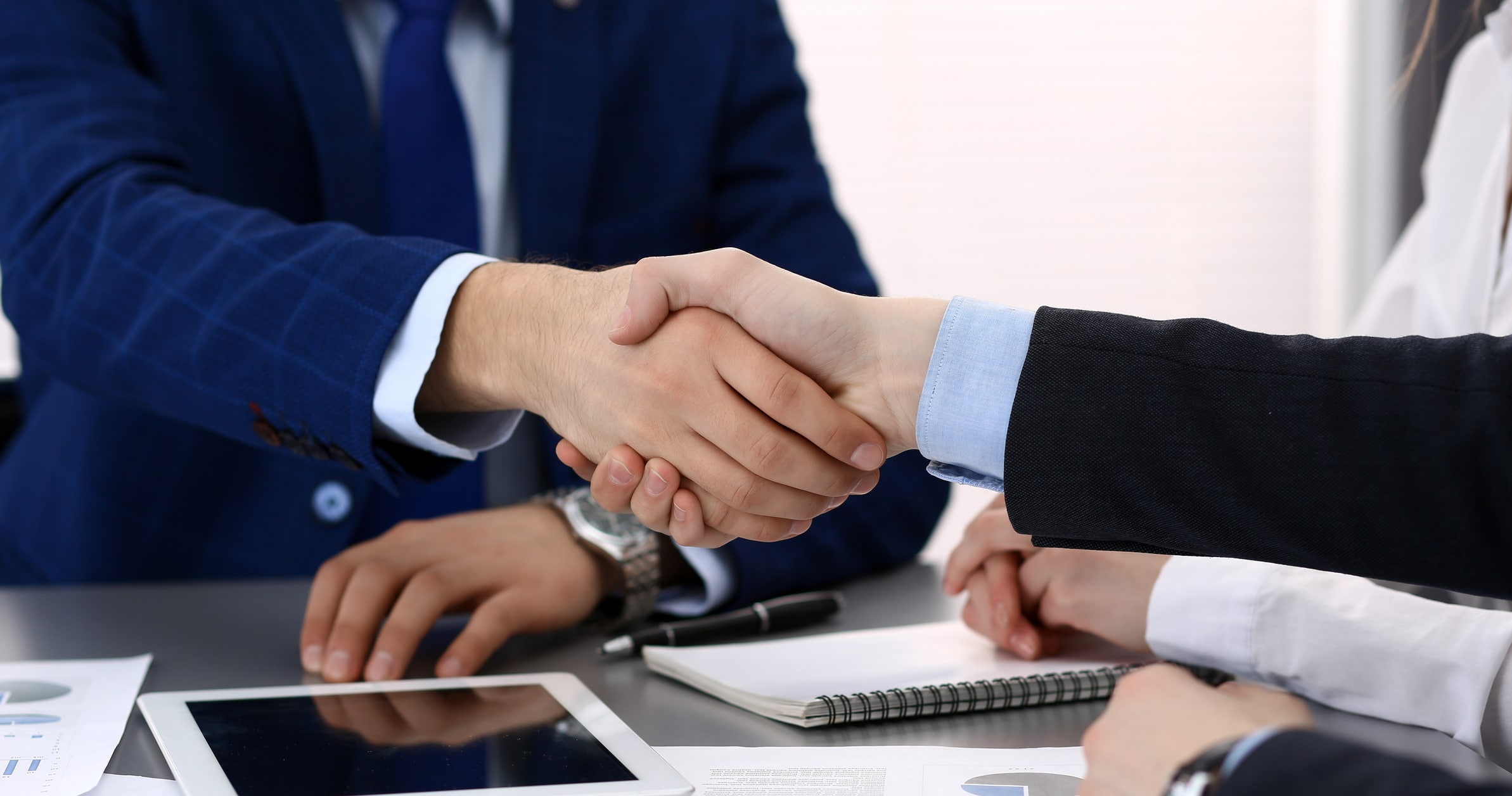shaking hands in business setting