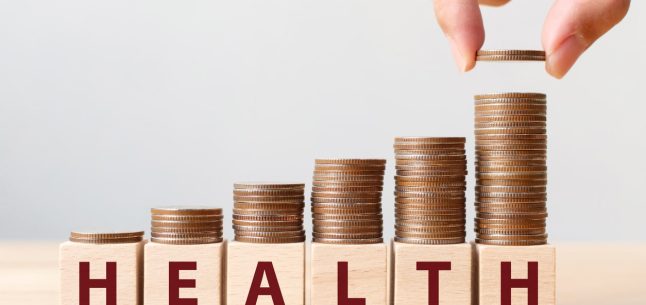 health stacking coins on wooden blocks