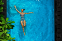 woman floating on back in pool