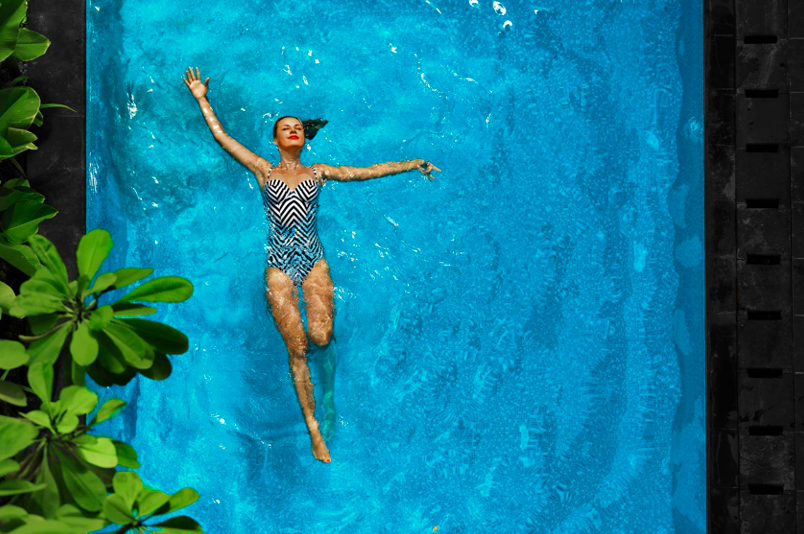 woman floating on back in pool